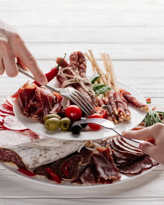 People grabbing appetizers at a party.