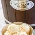 A bowl of homemade French vanilla ice cream and an ice cream maker.