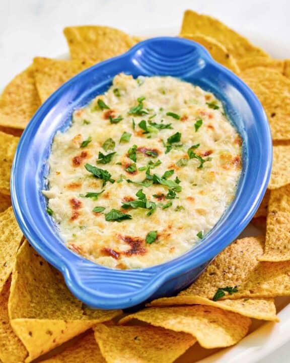 Copycat Joe's crab shack crab dip and tortilla chips on a platter.
