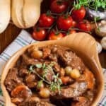 Homemade Julia Child beef bourguignon, bread, tomatoes, and mushrooms.