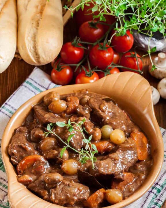 Homemade Julia Child beef bourguignon, bread, tomatoes, and mushrooms.