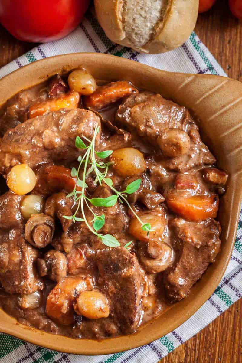 A serving of homemade Julia Child beef bourguignon on a cloth napkin.