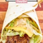 Homemade McDonald's big mac wrap on a wood cutting board.