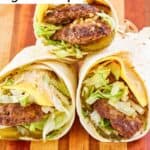 Three homemade McDonald's big mac wraps on a wood board.