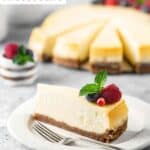 A slice of New York style cheesecake and a fork on a small plate.