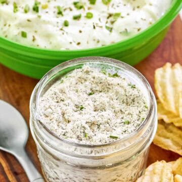 Homemade ranch dressing mix in a mason jar and ranch dip behind it.