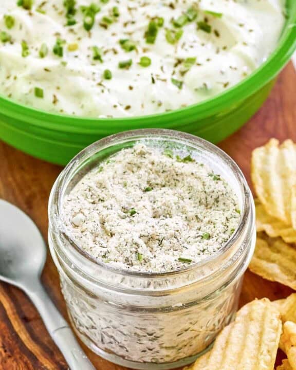Homemade ranch dressing mix in a mason jar and ranch dip behind it.