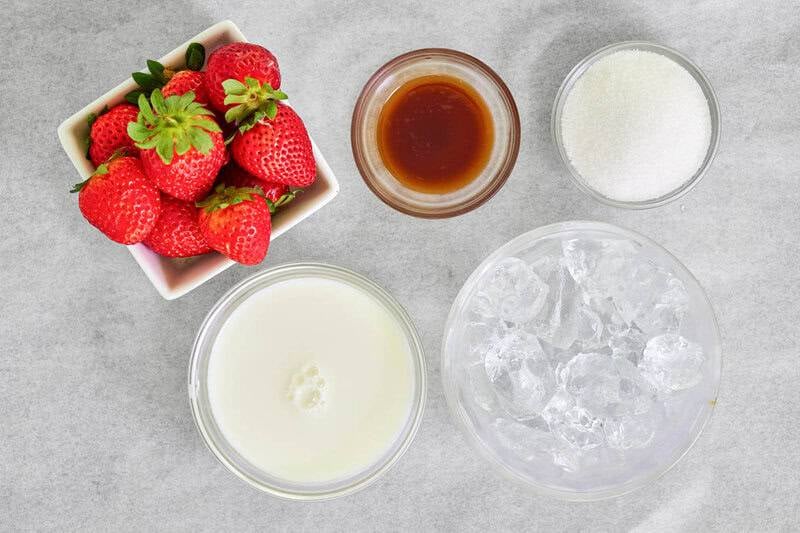 Copycat strawberry julius ingredients in bowls.