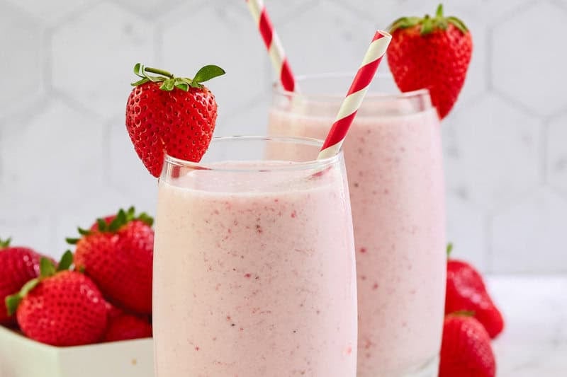 Copycat strawberry julius garnished with a strawberry.