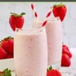Homemade strawberry juilus garnished with fresh strawberries in two glasses.