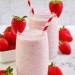 Homemade strawberry juilus in two glasses and fresh strawberries.