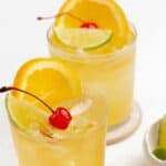 Two glasses of copycat Applebee's white peach sangria on coasters.