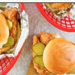 Homemade Chick-fil-A chicken sandwiches in baskets and on a wood board.