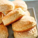 Several homemade Cracker Barrel biscuits on a plate.
