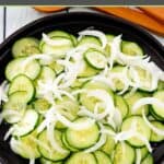 Cucumber onion salad on a round platter.