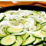 Cucumber onion salad on a platter.