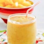 A bowl of pineapple chunks and a glass of dole whip with rum float.