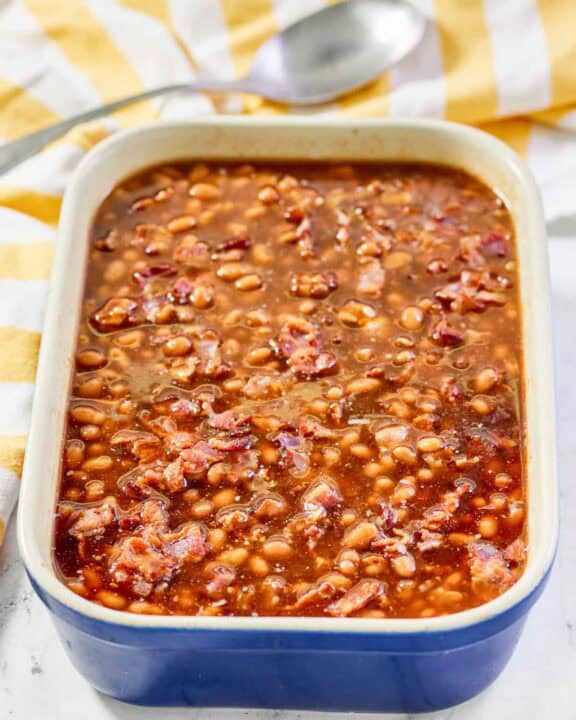 Copycat Durgin Park Boston baked beans and a serving spoon behind it.
