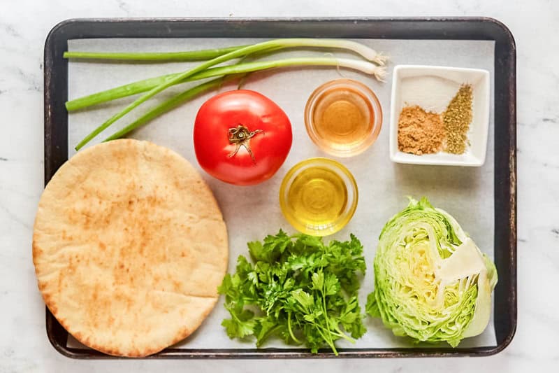 Copycat green jacket salad and dressing ingredients on a tray.