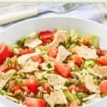 Homemade green jacket salad with dressing in a bowl.
