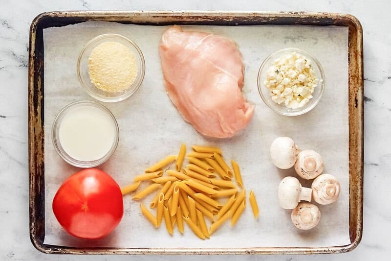Copycat Johnny Carino's chicken penne gorgonzola ingredients on a tray.