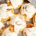 Homemade maple cream cheese frosting on cinnamon rolls.