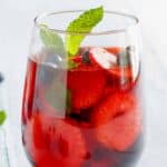 Homemade Olive Garden berry sangria in a stemless wine glass.
