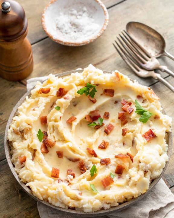 Copycat Ponderosa Steakhouse loaded mashed potatoes on a wood table.
