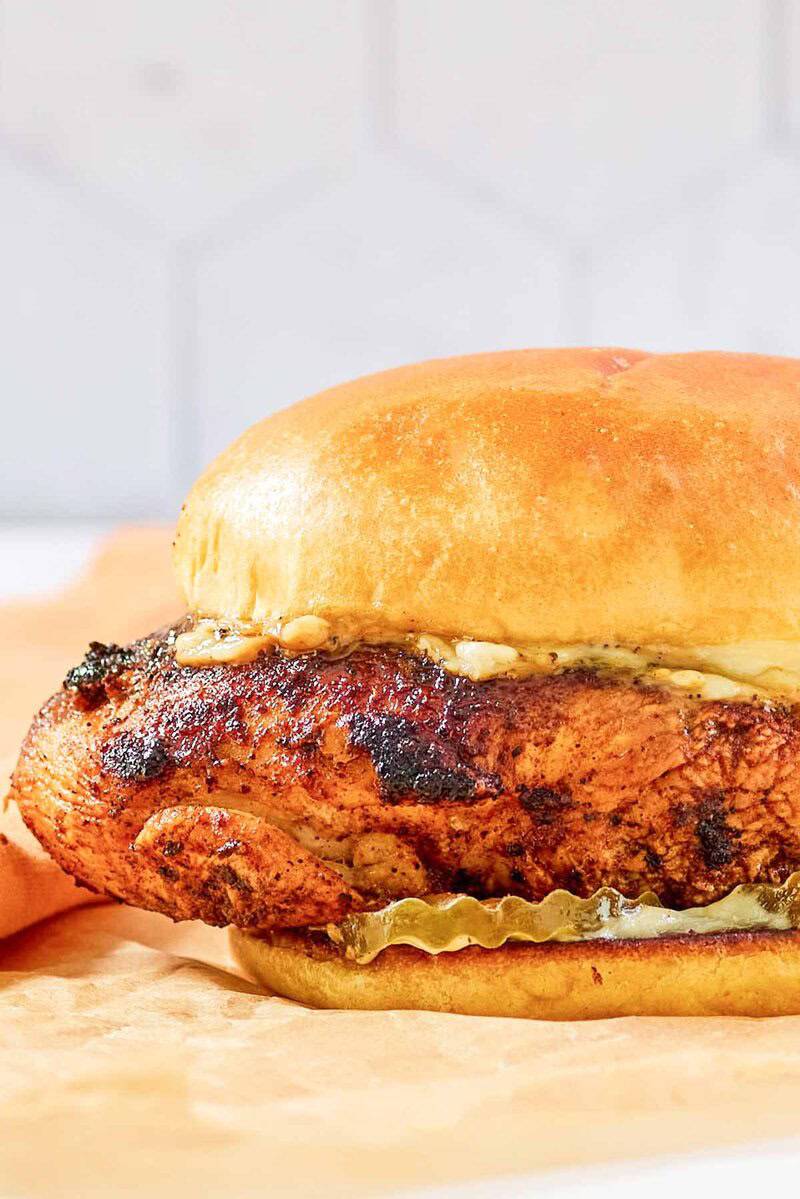 Copycat Popeyes blackened chicken sandwich with mayo and pickles.