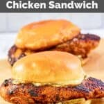 Two homemade Popeyes blackened chicken sandwiches on parchment paper.