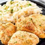 Crispy potato flake chicken and mashed potatoes on a plate.