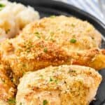Two pieces of potato flake baked chicken on a plate.
