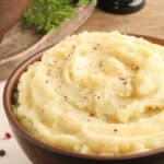 Homemade simple mashed potatoes in a wood bowl.