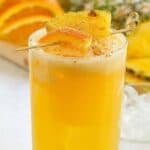 Copycat Soggy Dollar Bar painkiller drink garnished with orange and pineapple.