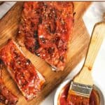 Homemade St. Louis style BBQ sauce on ribs and in a small cup.