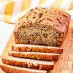 Copycat Starbucks banana walnut and pecan bread loaf on a wood board.