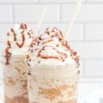 Copycat Starbucks mocha frappuccino drinks with whipped cream and chocolate sauce on top.