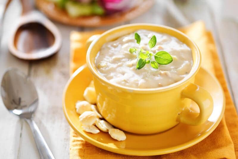Copycat Sweet Tomatoes clam chowder and a spoon next to it.