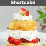 Homemade Ted's strawberry shortcake and a flower on a plate.