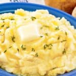Homemade yukon gold mashed potatoes with butter on top.