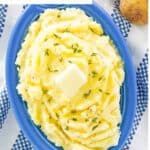 Homemade yukon gold mashed potatoes garnished with butter and thyme.