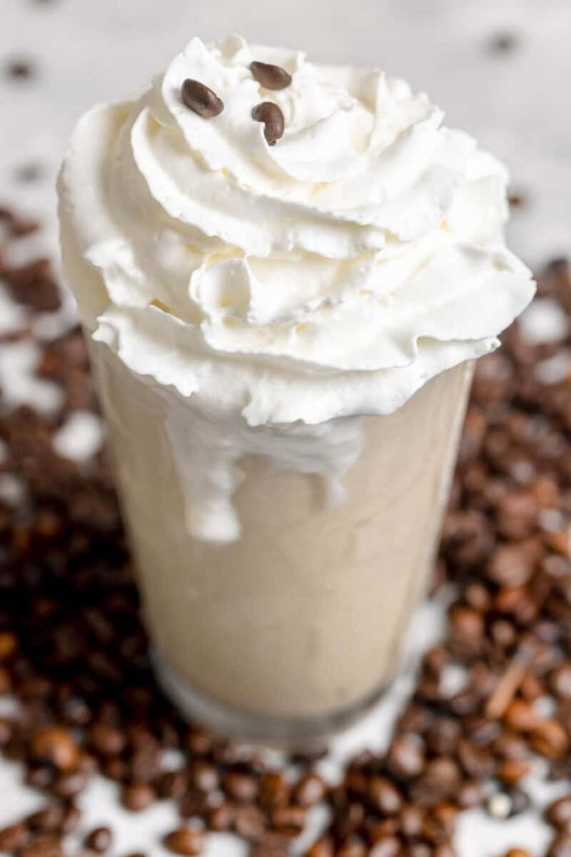 Copycat Chick-fil-A frosted coffee and coffee beans scattered around it.