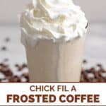 Homemade Chick-fil-A frosted coffee in a tall glass and coffee beans around it.