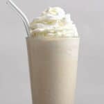 Homemade Chick-fil-A frosted coffee and coffee beans around it.