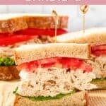 Homemade chicken salad chick barbie-q chicken salad sandwich with lettuce and tomato.