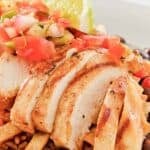 Copycat Chili's margarita grilled chicken served over black beans.