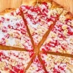 Homemade Cicis cherry pizza on a wood board.