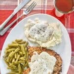 Copycat Cracker Barrel country fried steak and gravy on a plate.