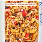 Frito taco salad with catalina dressing on a platter.