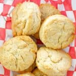 Homemade KFC buttermilk biscuits piled on parchment paper.